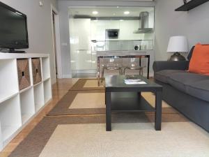 a living room with a couch and a table at Apartamento Virgen del Carmen in Santoña