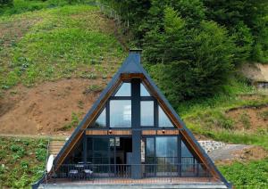 a house with a glass roof on a hill at BULUT BUNGALOW in Akcaabat
