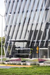 a building with a sign on the side of it at AC Hotel by Marriott Guadalajara Mexico in Guadalajara