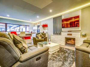 a living room with a couch and a fireplace at Eagle Rock Executive Guest House in Kempton Park