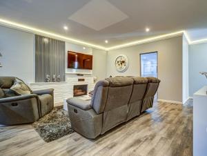 a living room with a couch and a fireplace at Eagle Rock Executive Guest House in Kempton Park