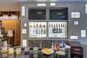 a bar with a lot of bottles of alcohol at Courtyard by Marriott Appleton Riverfront in Appleton