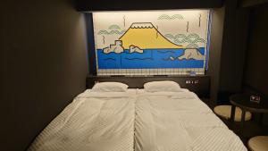 Postel nebo postele na pokoji v ubytování HOTEL TAVINOS Kyoto