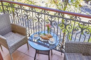 a table with a plate of food on a balcony at Royal Street Hotel in Odesa