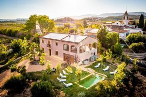 an aerial view of a house with a swimming pool at Masia Cal Magi in Font-Rubí