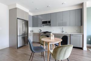 a kitchen with a table and chairs and a refrigerator at Mountain View 1br w spa lounge wd nr shops SFO-1415 in Los Altos