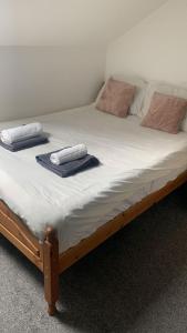 a bed with two towels on top of it at Mapperley House - UNDER NEW MANAGEMENT PROMOTIONAL RATES AVAILABLE in Nottingham