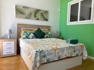 Aparment sierra Guadalupe في مدريد: غرفة نوم بسرير مع جدران خضراء