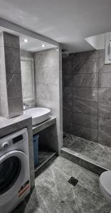 a bathroom with a washing machine and a sink at Mimarxos Luxury Apartments in Chalkida
