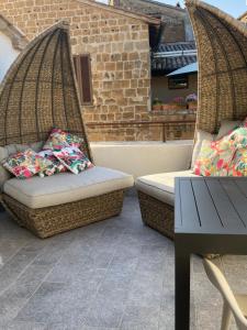 two wicker chairs sitting on a patio with a table at BB Orvieto in Orvieto