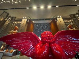 a large red sculpture of a flower in a room at Le Méridien Emei Mountain Resort in Emeishan