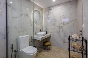 a bathroom with a toilet and a sink at Pap's Lab Apartments in Heraklio