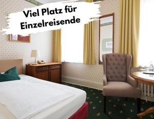 a hotel room with a bed and a desk and a chair at Boutique-Hotel Amalienhof in Weimar