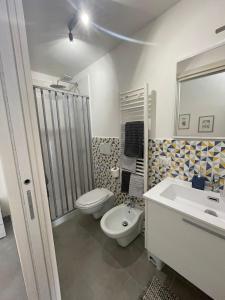 a bathroom with a toilet and a sink at Impero5 Guest House in Acquaviva delle Fonti