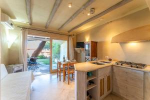 a kitchen with a sink and a stove top oven at ISA-Residence in Marinella at only 450 m from the beach, apartments with air conditioning in Marinella