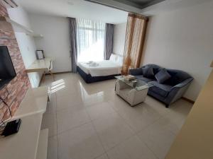a living room with a couch and a bed at CA&SA Serviced Apartment in Phnom Penh