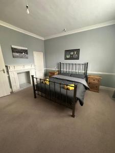 a bedroom with a bed and a fireplace at Historical and Quirky Home in Braintree