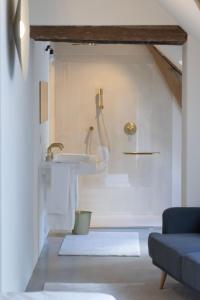 a white bathroom with a sink and a sink at Château du Pont d'Oye in Habay-la-Neuve