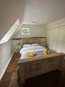a bedroom with a bed with two teddy bears on it at Historical and Quirky Home in Braintree