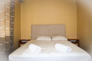 a bed in a room with two pillows on it at Casafamiglia in Prolesha