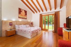 a bedroom with a bed and a television in it at La Forca in Santa Margalida +81 photos
