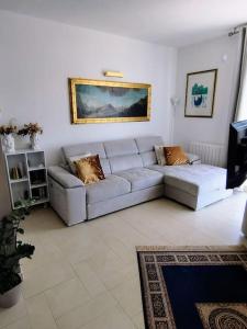 a living room with a couch and a painting on the wall at I love Pesaro in Pesaro