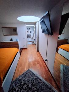 a room with two beds and a flat screen tv at I love Pesaro in Pesaro