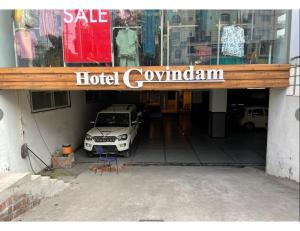 a car is parked inside of a hotel carillion at Hotel Govindam, Ujjain in Ujjain
