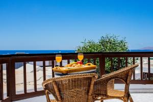 a table with a tray of fruit and two glasses of wine at Penthouse Ocean View Puerto del Carmen in Puerto del Carmen