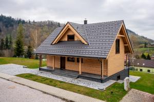 a house with a metal roof on top of it at CHALET Martuška in Levoča