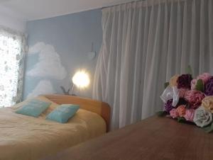 a bedroom with a bed with flowers on it at Hill House with City view in Dezmir