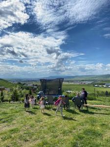 a group of people standing in a field at Hill House with City view in Dezmir