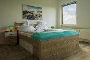 Кровать или кровати в номере City Apartments Wilhelmshaven