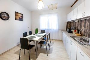 a kitchen with a table and chairs in a room at Casuta cu View in Sighişoara