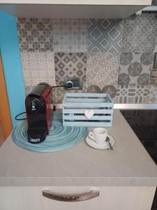 a coffee maker and a cup on a counter at Casa Vacanza Blue Sea in San Vito lo Capo