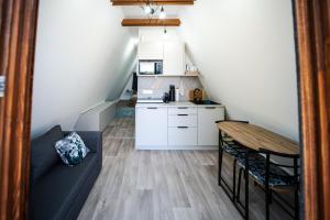 a small living room with a couch and a table at Volenter Lux Duna Spa in Baja