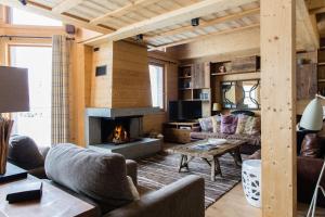 a living room filled with furniture and a fireplace at Chalet Le Favre in Chamonix-Mont-Blanc