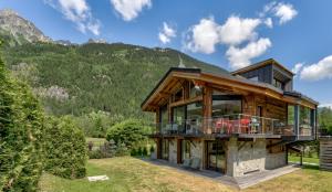 a log home with a view of the mountains at Chalet Red Fox in Chamonix-Mont-Blanc