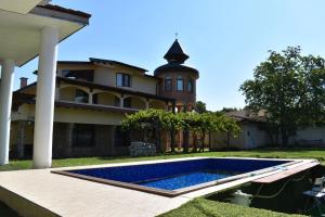 a house with a swimming pool in front of it at Casafamiglia in Prolesha