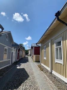 a cobblestone street next to a row of houses at In the heart of Old Rauma in Rauma
