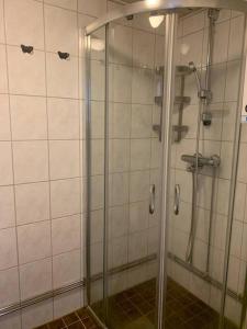 a shower with a glass door in a bathroom at In the heart of Old Rauma in Rauma
