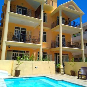 an apartment building with a swimming pool in front of it at résidence fleur de canne in Mont Choisy