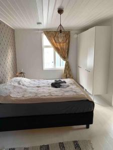 a bedroom with a large bed with a window at In the heart of Old Rauma in Rauma
