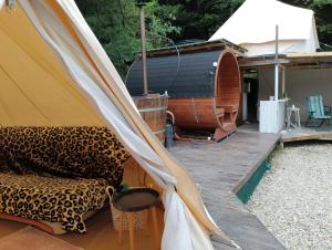 a tent and a couch on a wooden deck at Tiny House Village Resort 