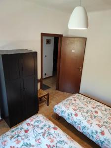 a bedroom with two beds and a dresser and a bed at Casabonsai in Fivizzano