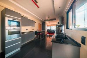 a kitchen with a sink and a stove top oven at Casa da Terça Nice View and Parking in Funchal