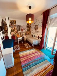 a living room with a bed and a window at B&BMagicHouse in Novara