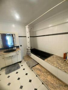 a bathroom with a shower and a tiled floor at Amplio y céntrico piso en Santoña in Santoña