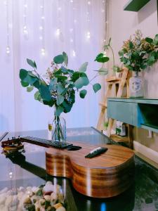 a glass table with a vase of flowers on it at Gentile's House next to Saturday Night Market in Chiang Mai