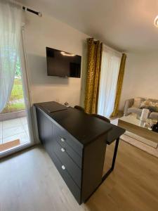 a black desk in a room with a living room at Le studio de Manon in Carquefou